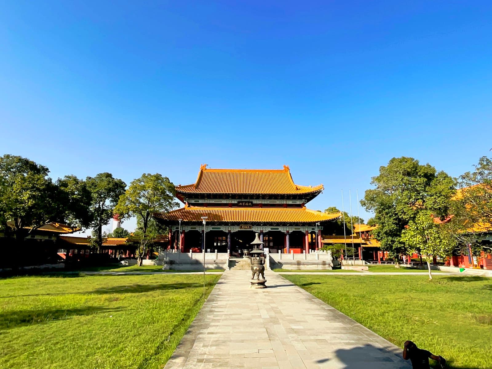 Lumbini — a person walking down a path in front of a building