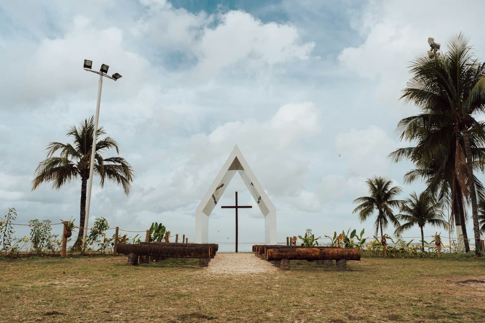 Maceió — a church with a cross and benches in front of it