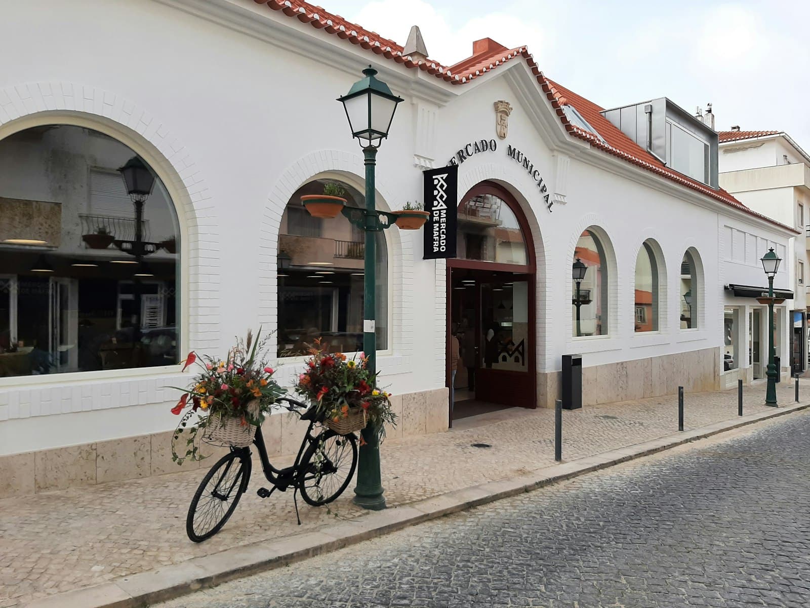 Mafra — a bike is parked outside of a building