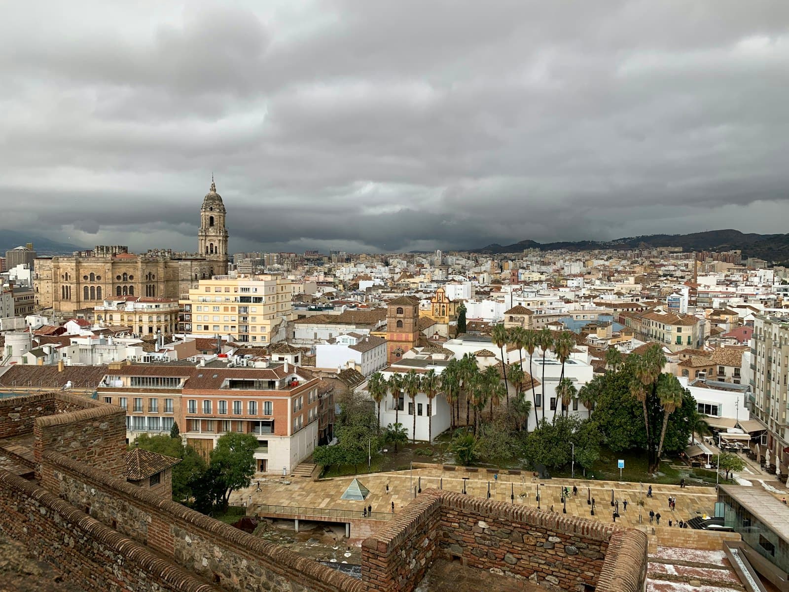 Málaga — city with high rise buildings under white cloudy sky during daytime