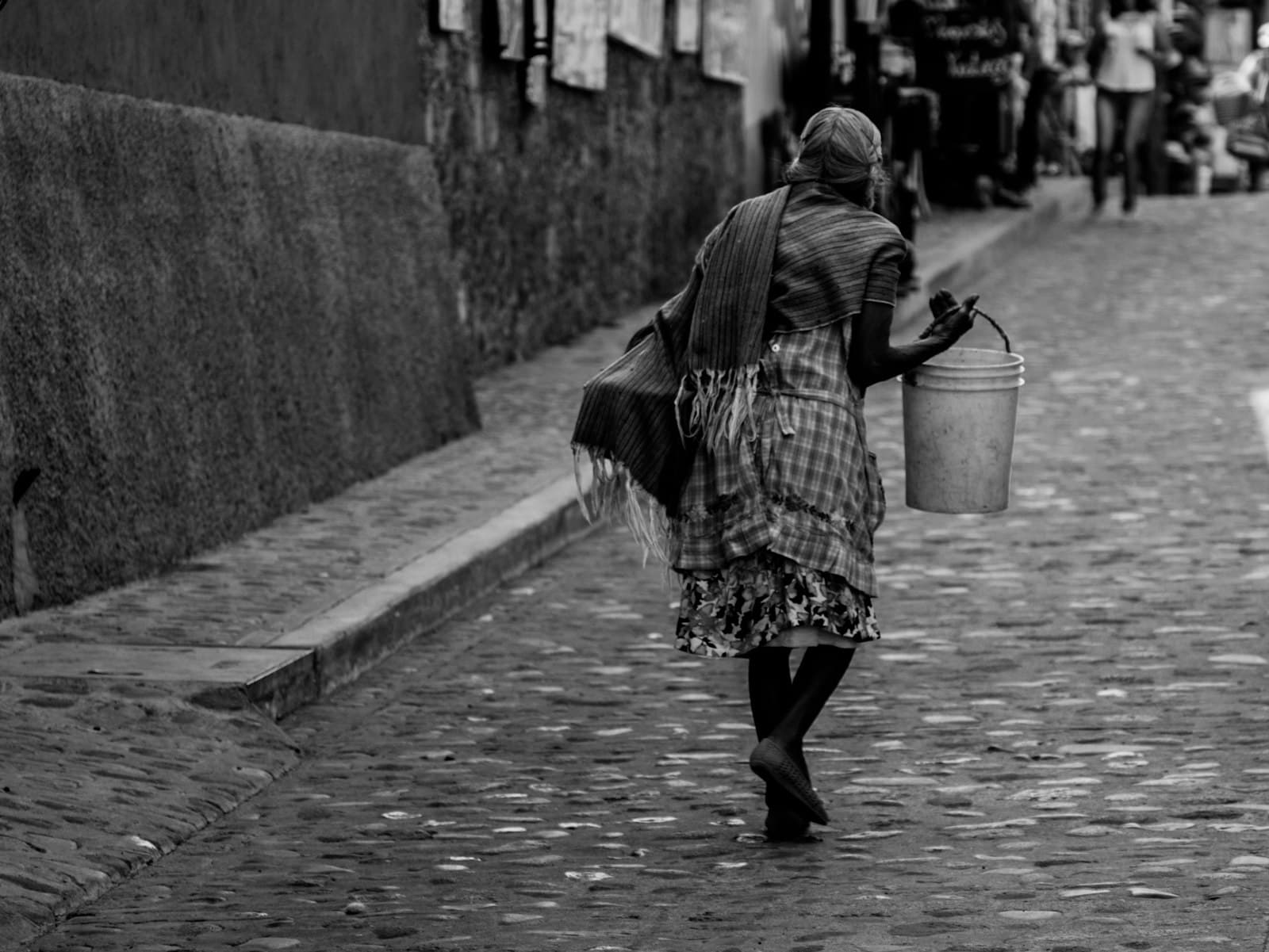 Malinalco — woman in black and white dress walking on sidewalk