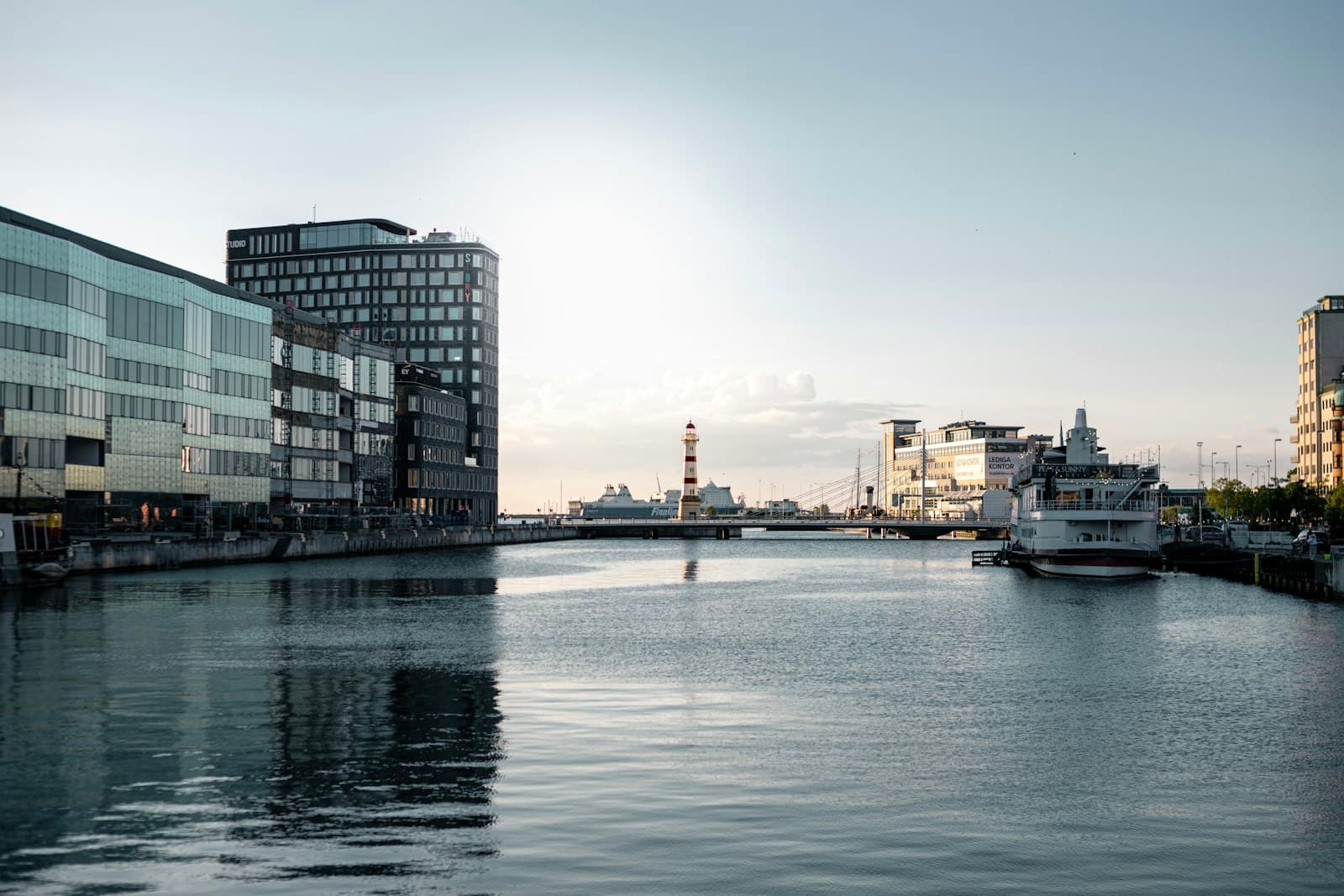 Malmö — white boat on water near city buildings during daytime