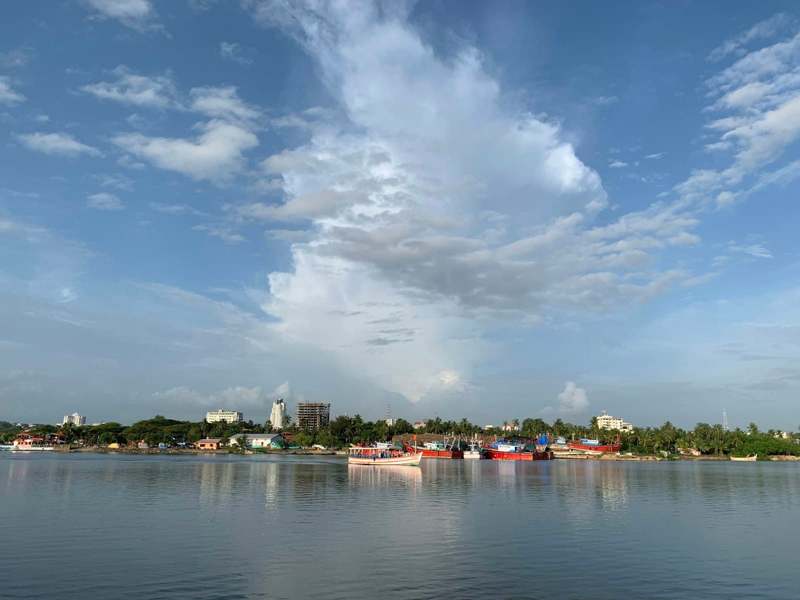 Mangalore — city with high-rise buildings near body of water under white and blue sky during daytime