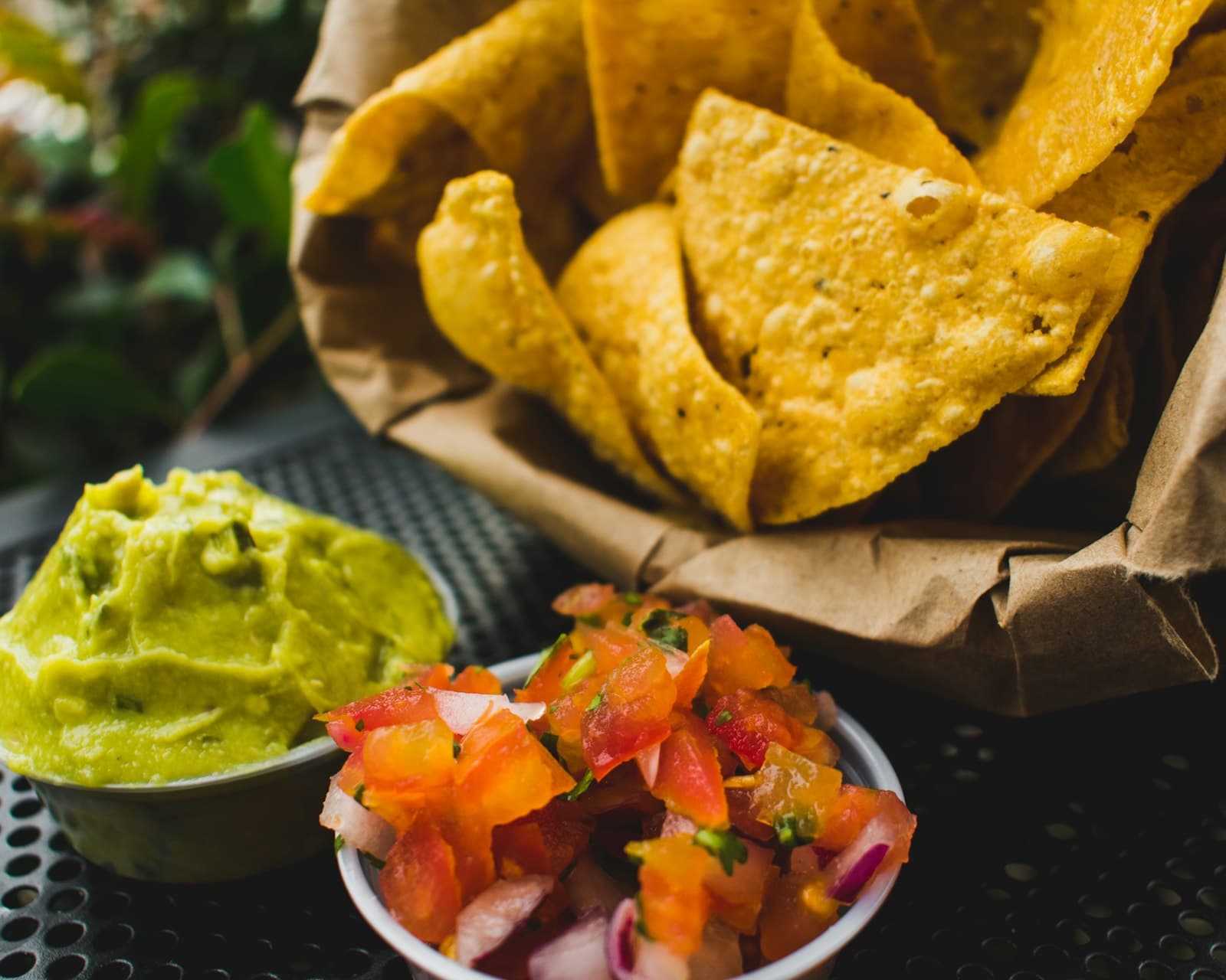 Manizales — fried crackers with red tomatoes and green sauce