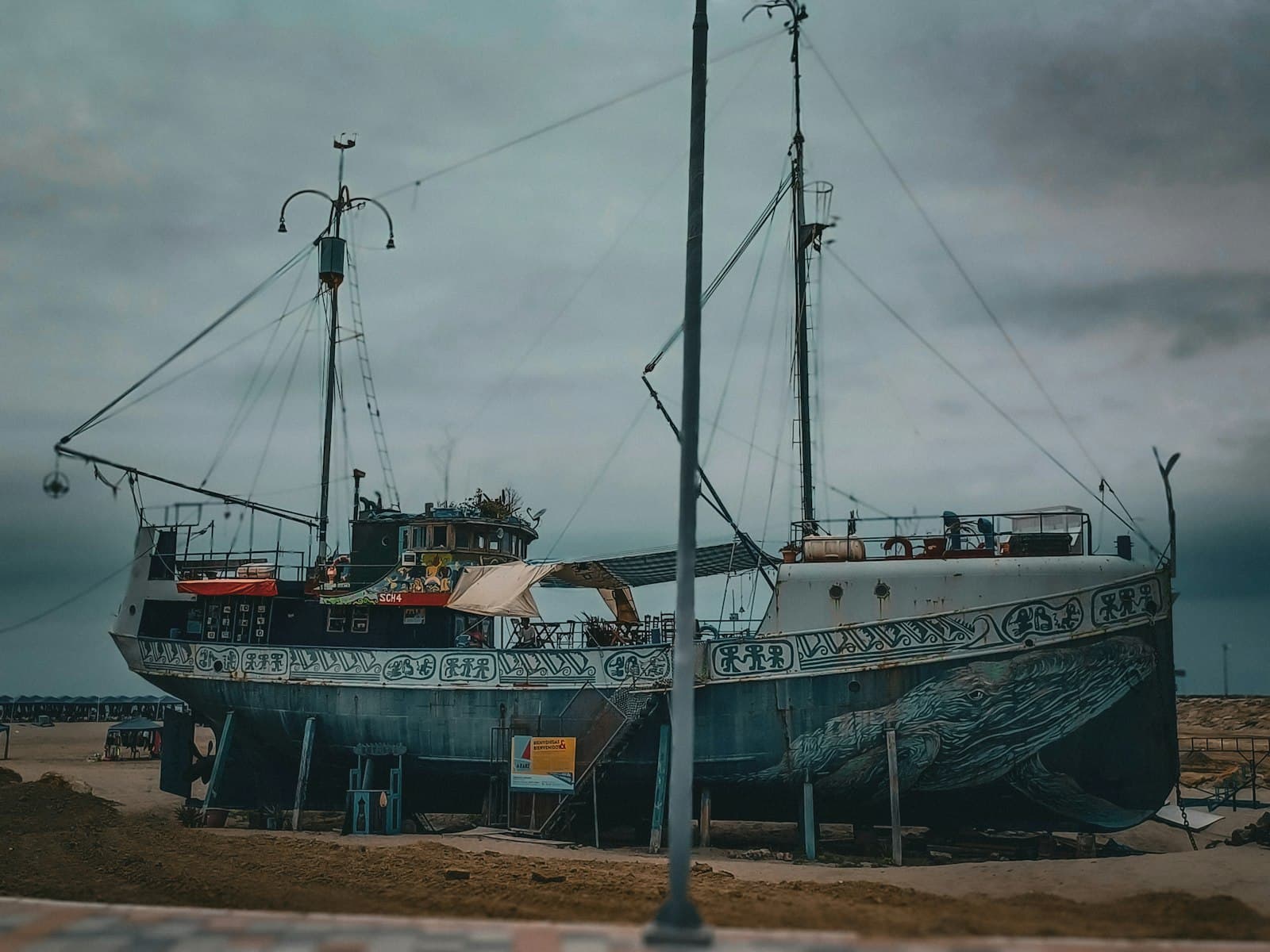 Manta — a large boat sitting on top of a sandy beach