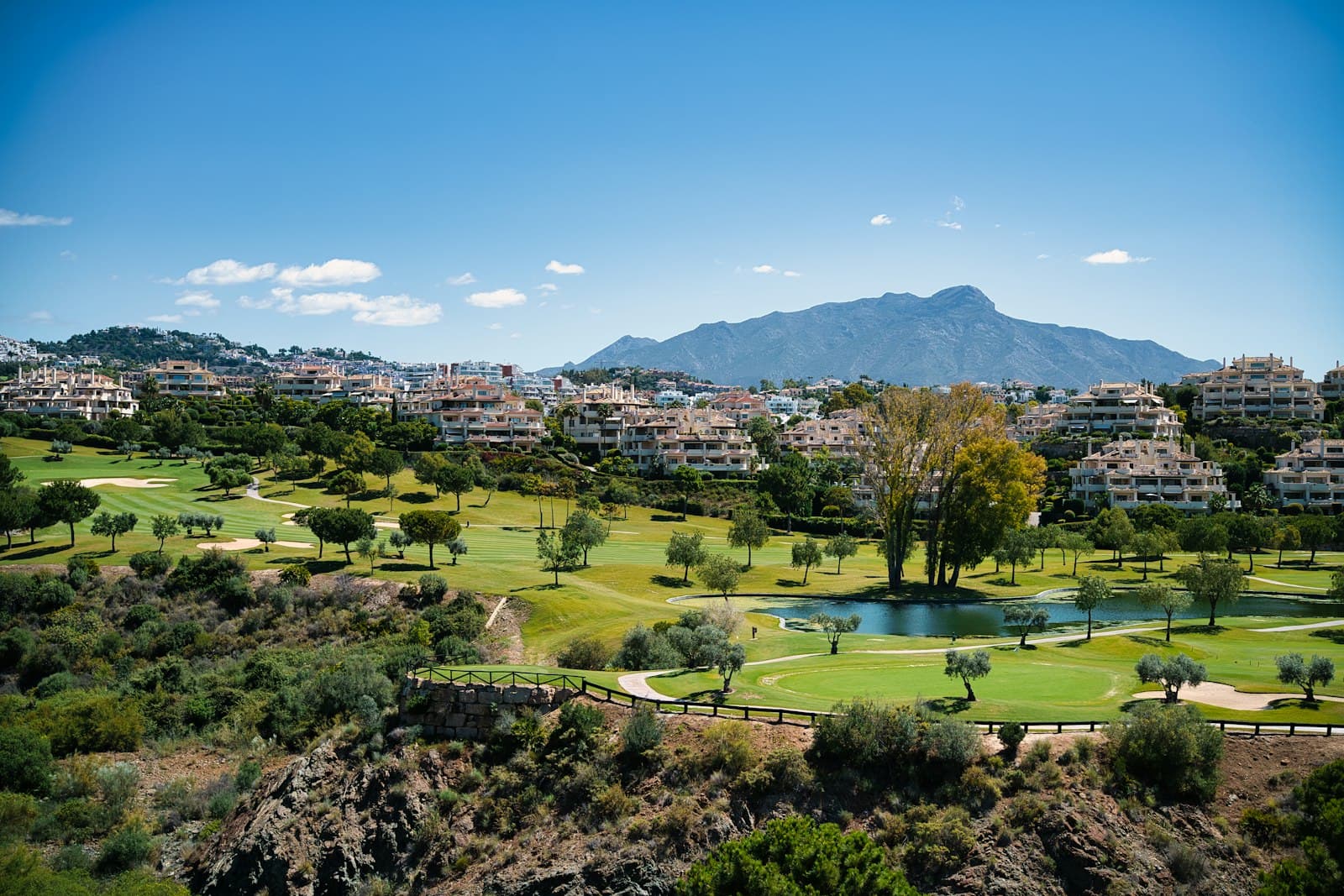 Marbella — A scenic view of a golf course and mountains