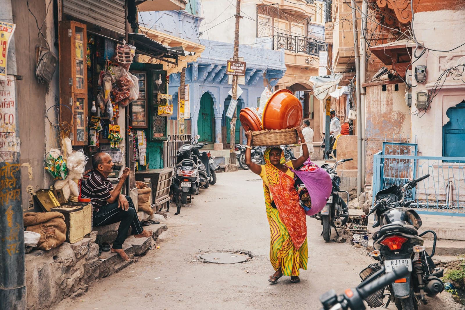 Margao — woman in yellow and red dress standing on sidewalk during daytime