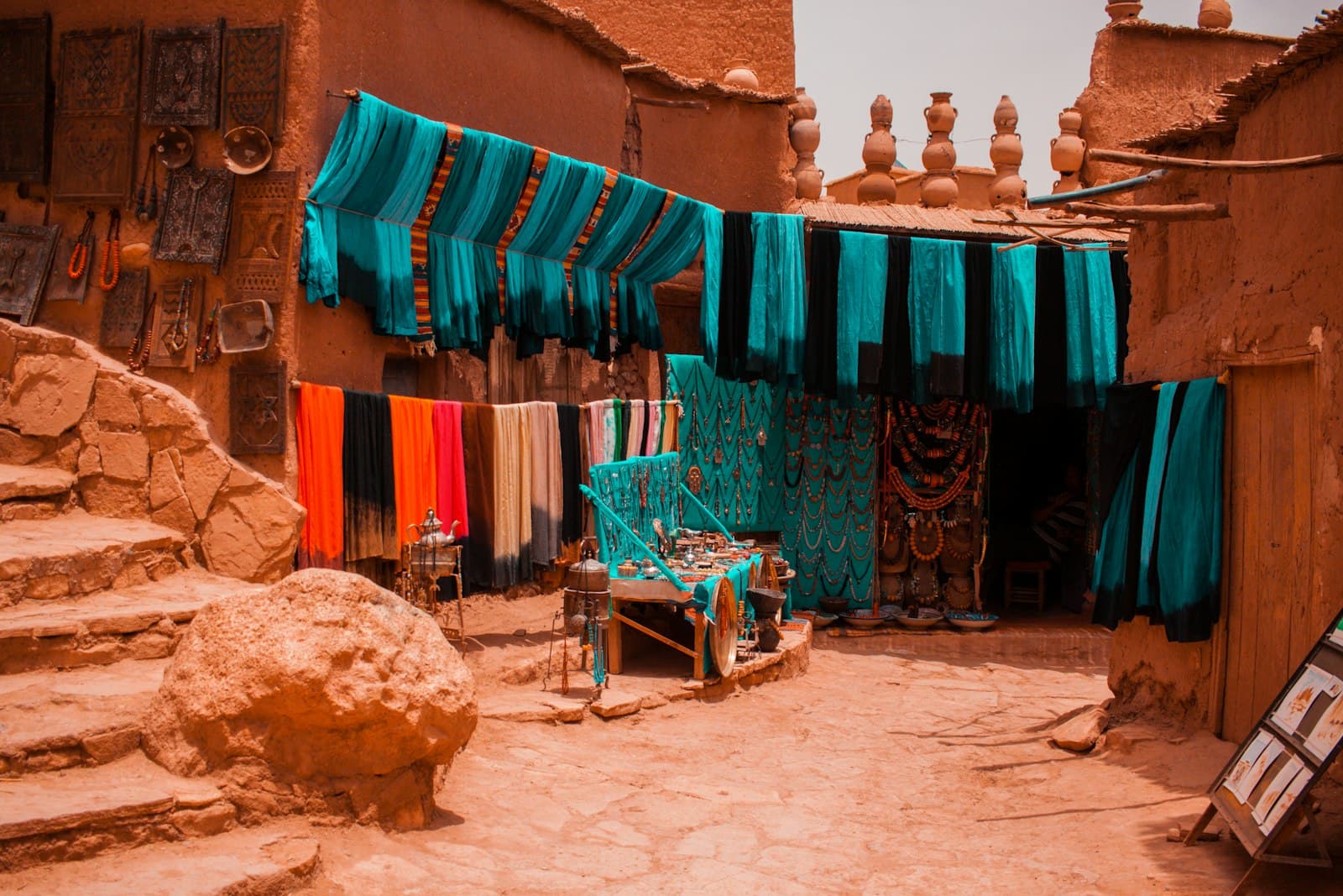 Marrakesh — assorted-color textiles hanged beside concrete buildings