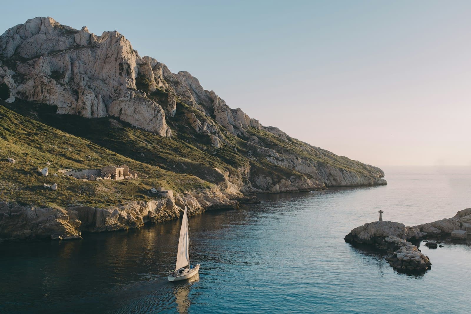 Marseille — white sailboat near island rocks