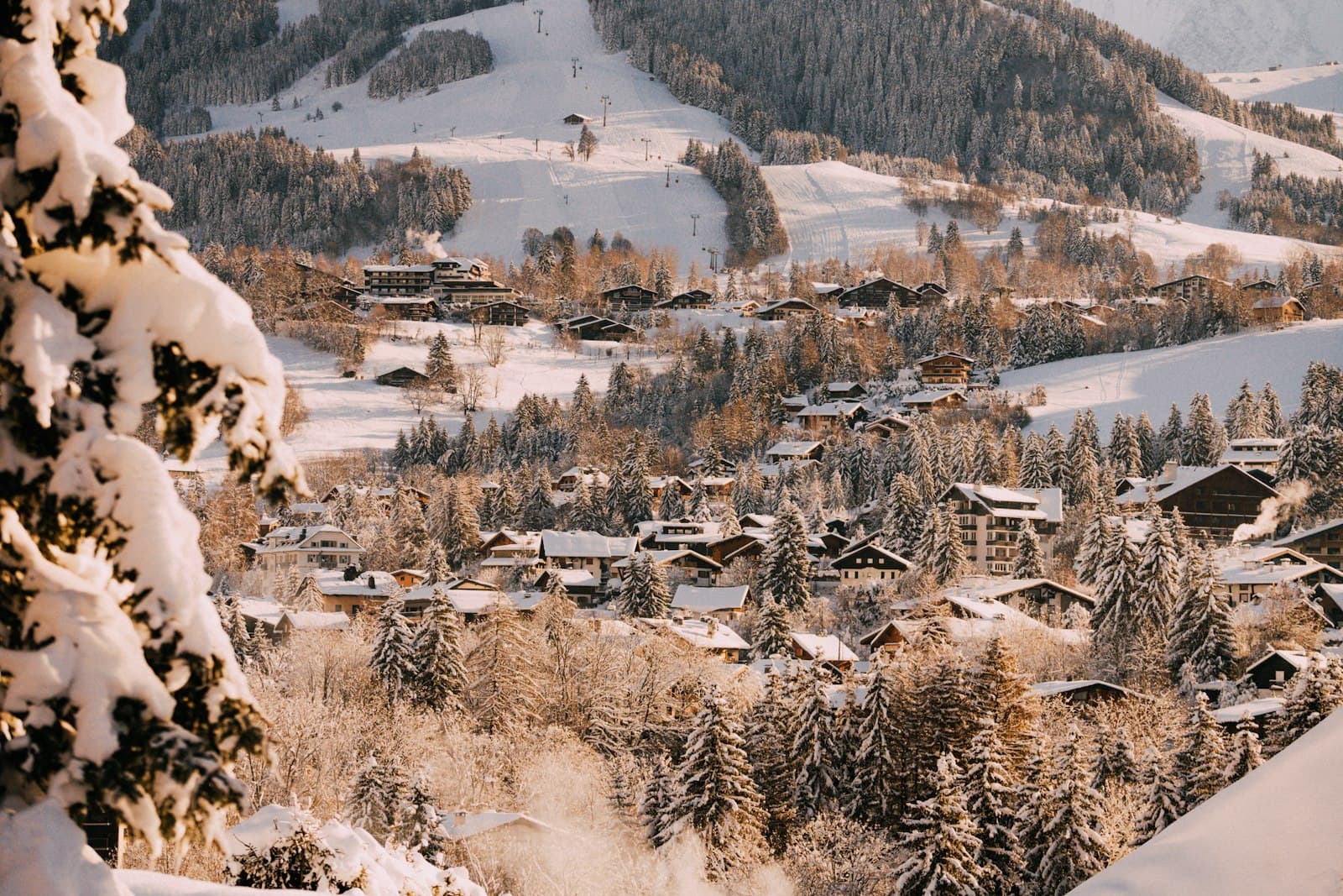 Megève — a snow covered mountain with a village in the distance
