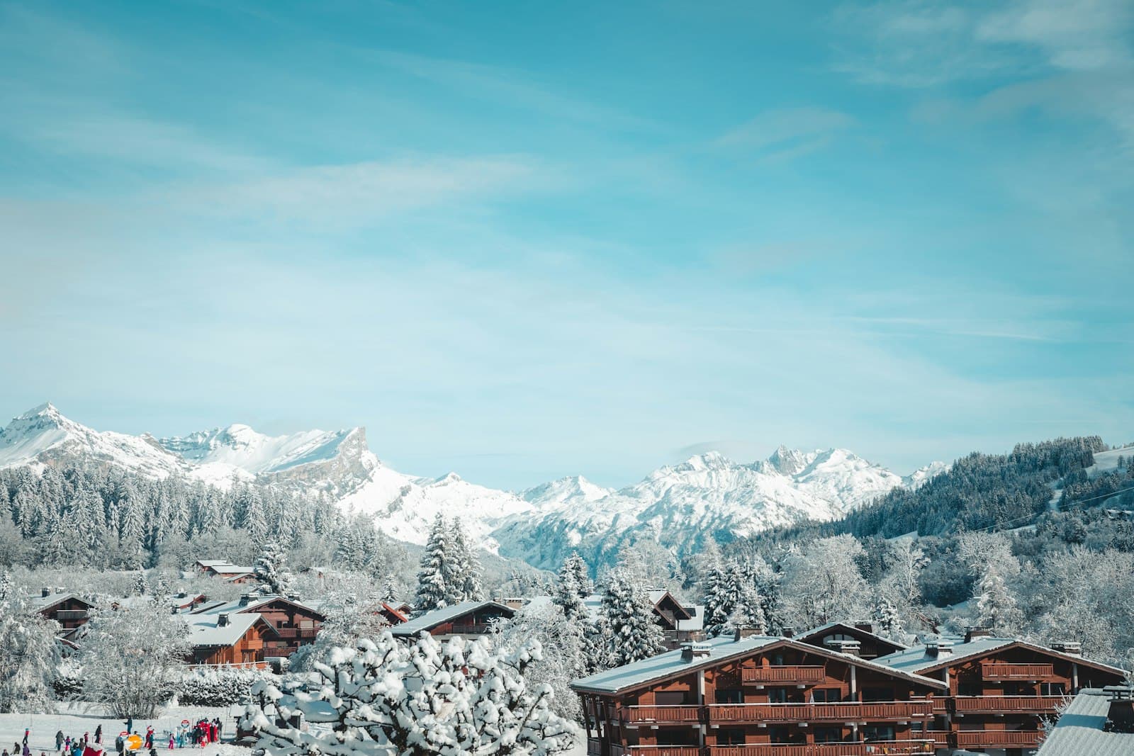 Megève — a group of people standing on top of a snow covered slope
