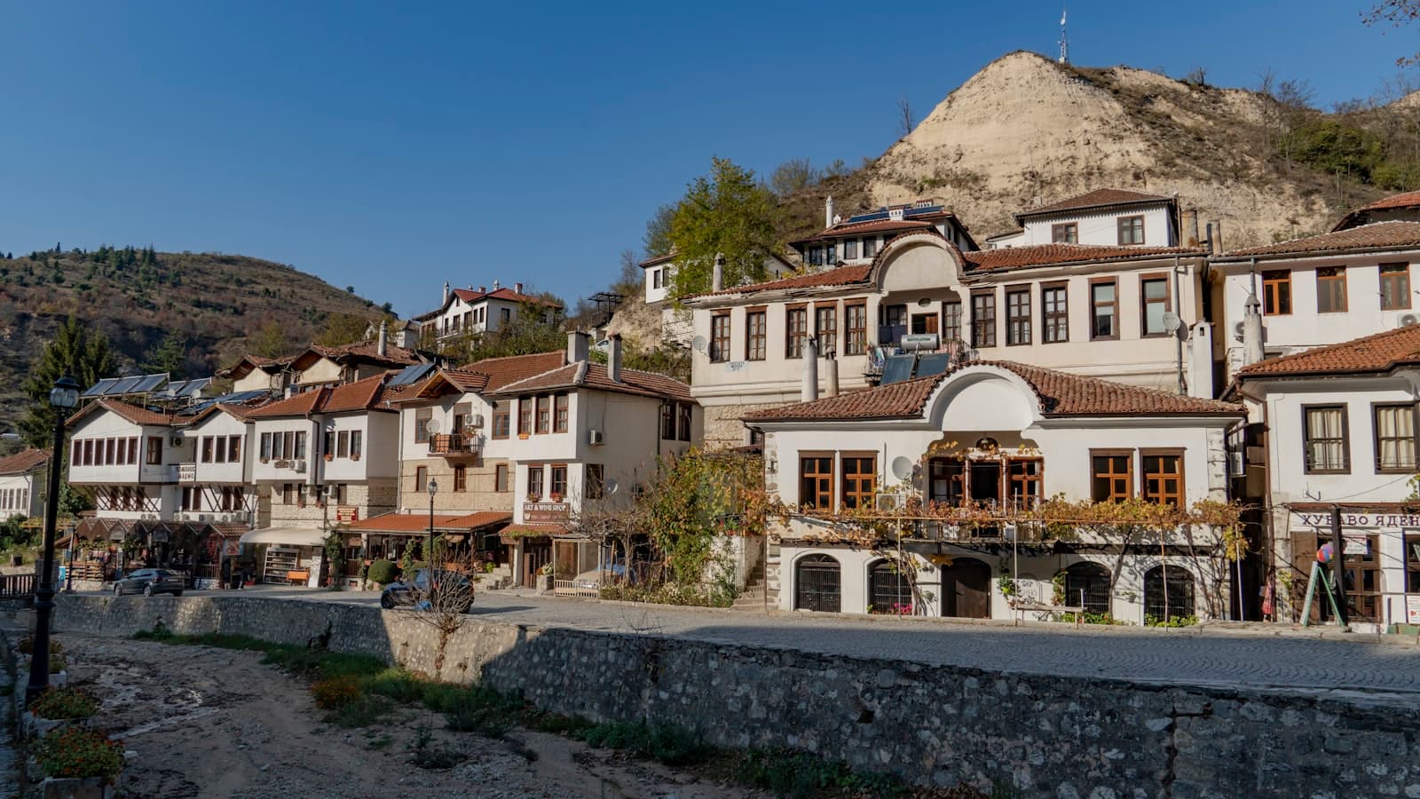 Melnik — a group of buildings with a hill in the background