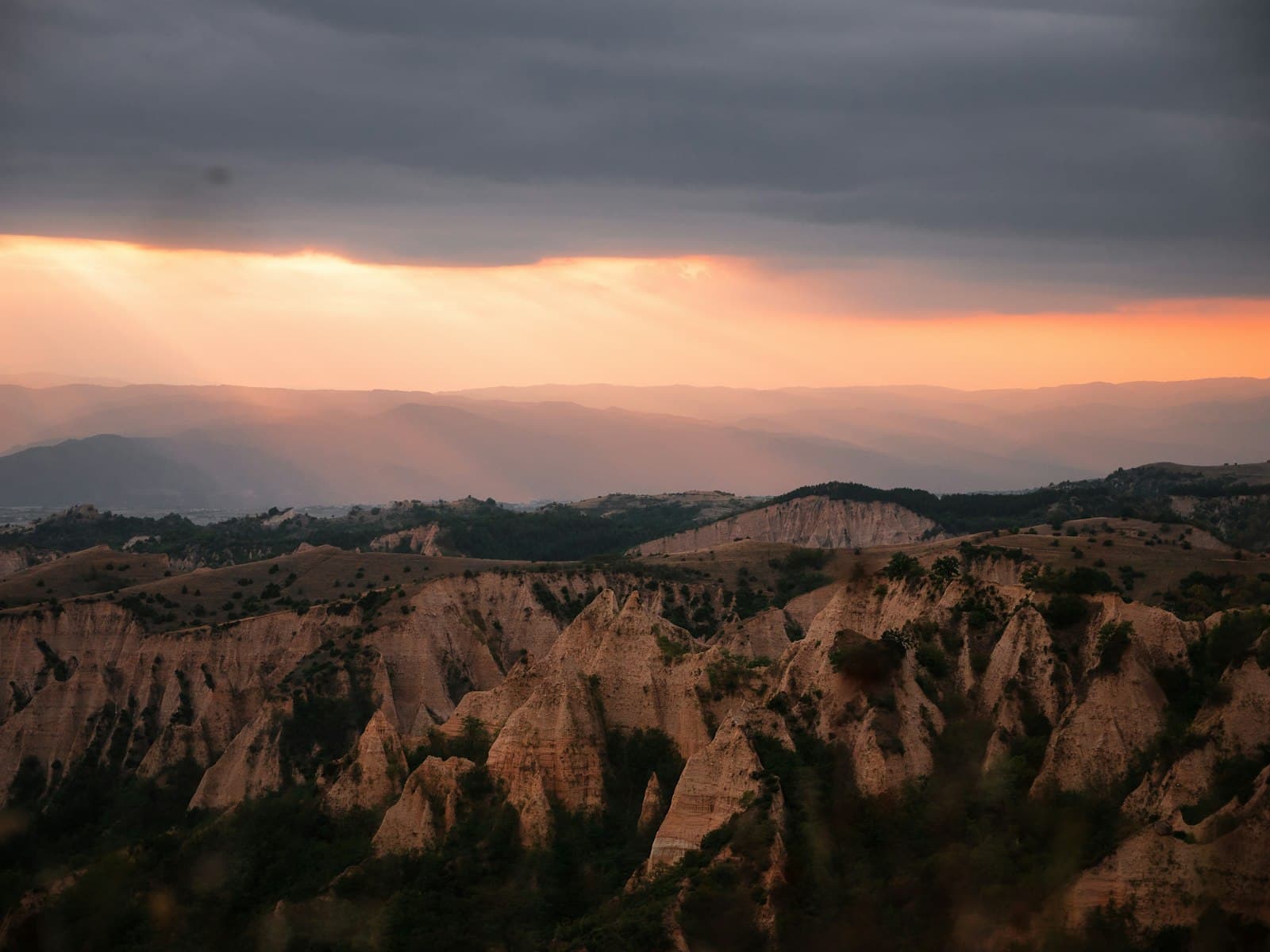 Melnik — the sun shines through the clouds over the mountains