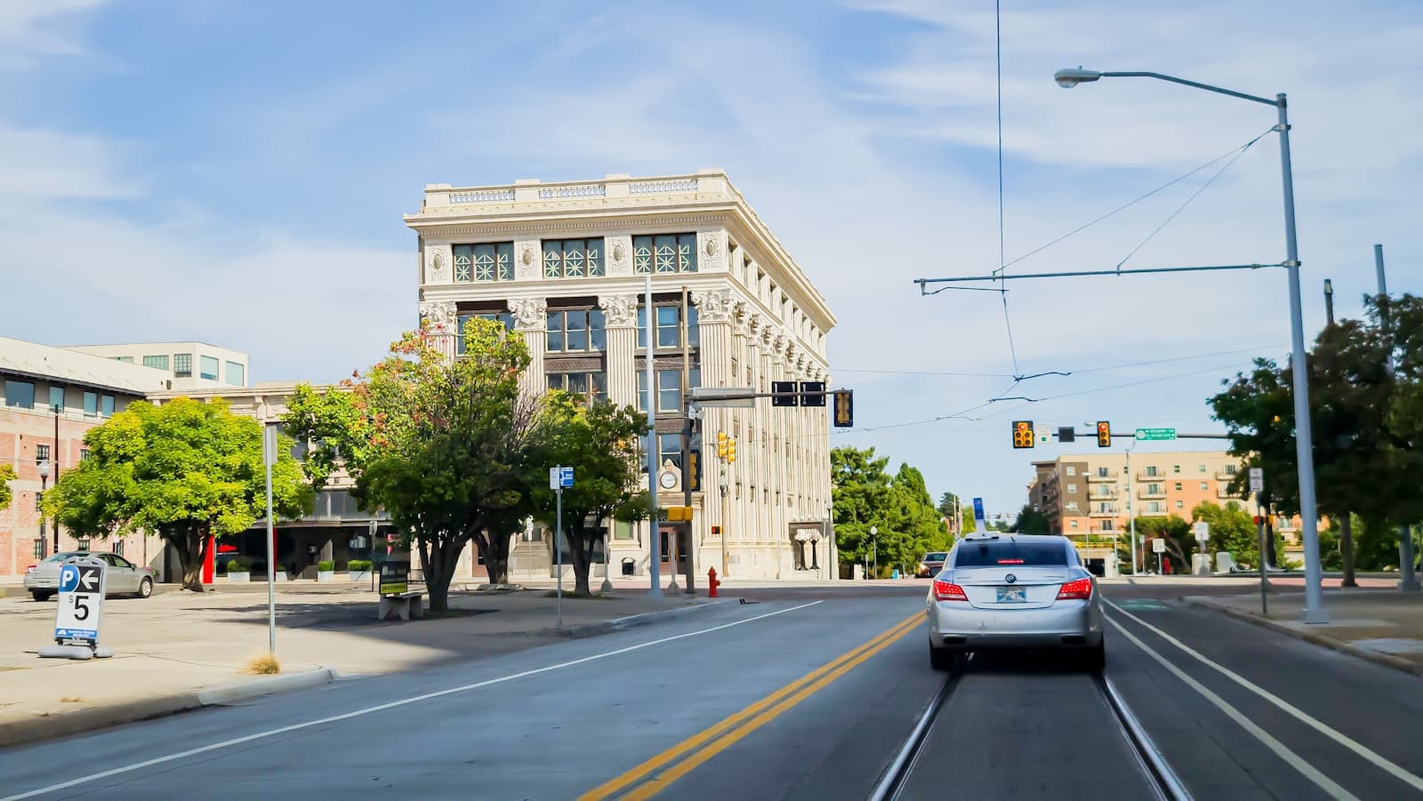 Memphis — a white car driving down a street next to a tall building