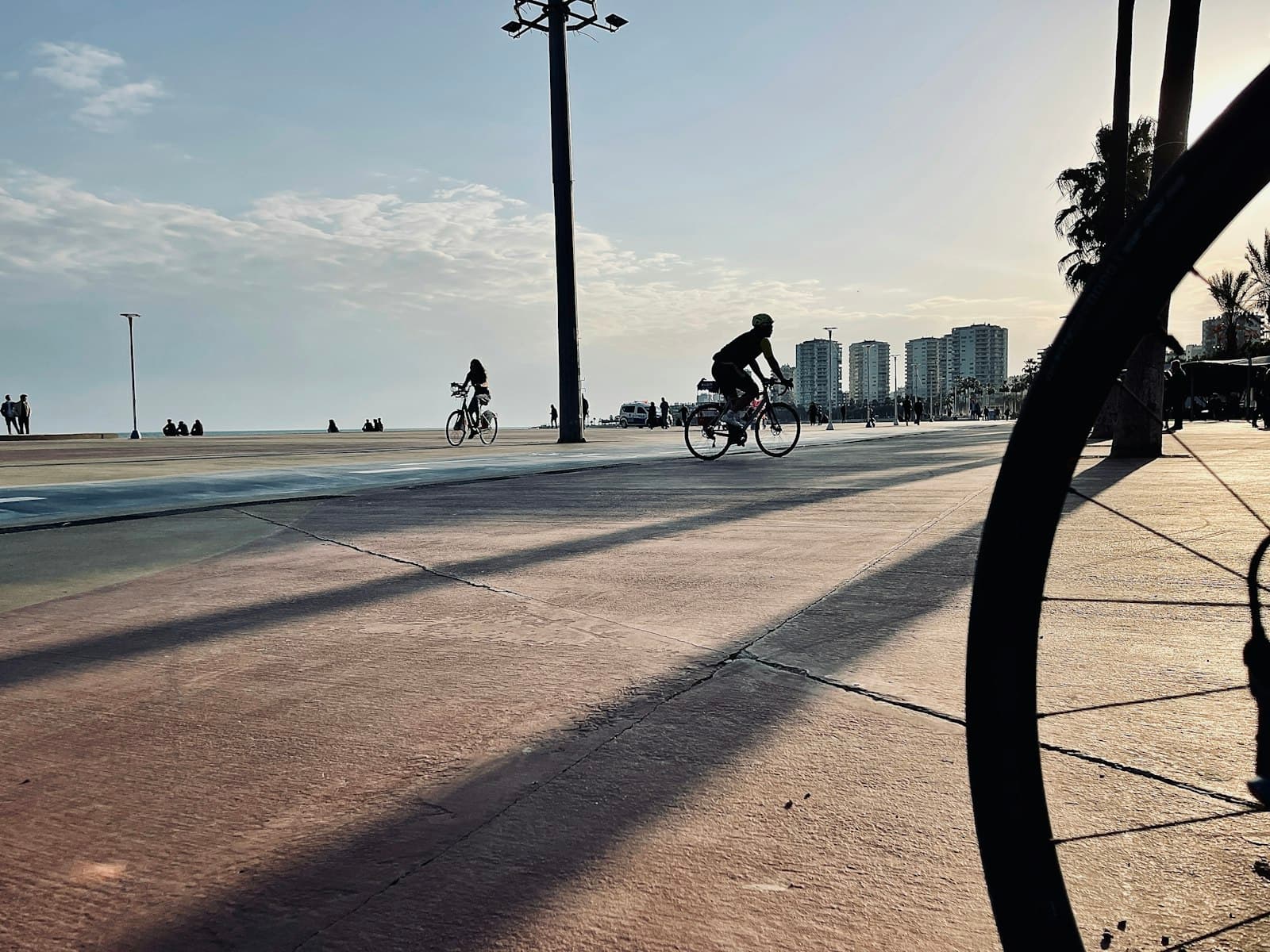 Mersin — a man riding a bike down a street next to tall buildings