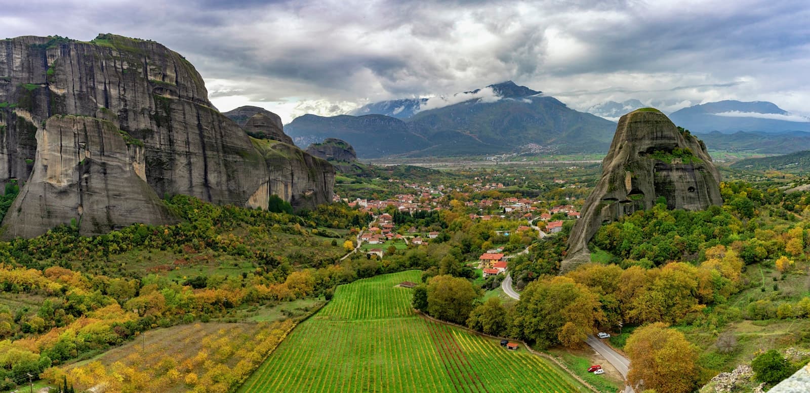 Metsovo — green grass field near mountain under white clouds during daytime