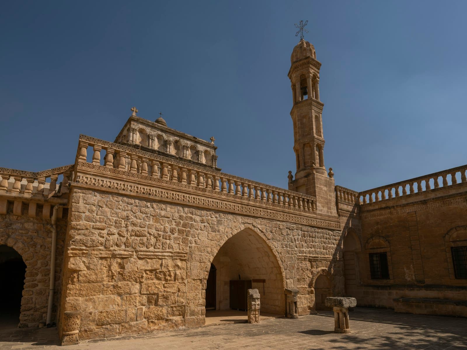 Midyat — a stone building with a clock tower in the background