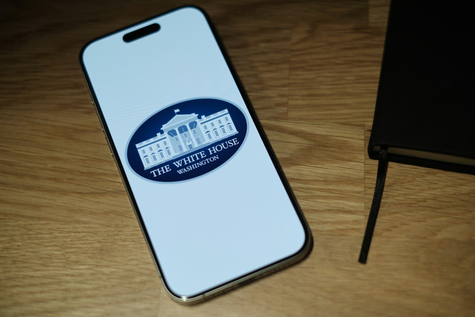 Mobile — A cell phone sitting on top of a wooden table