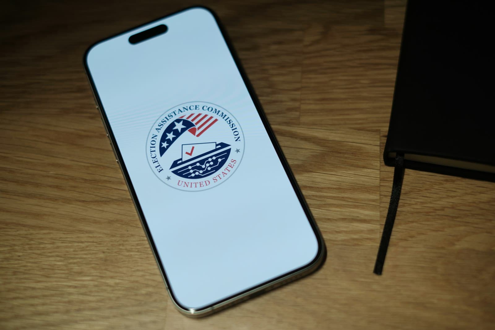Mobile — A cell phone sitting on top of a wooden table