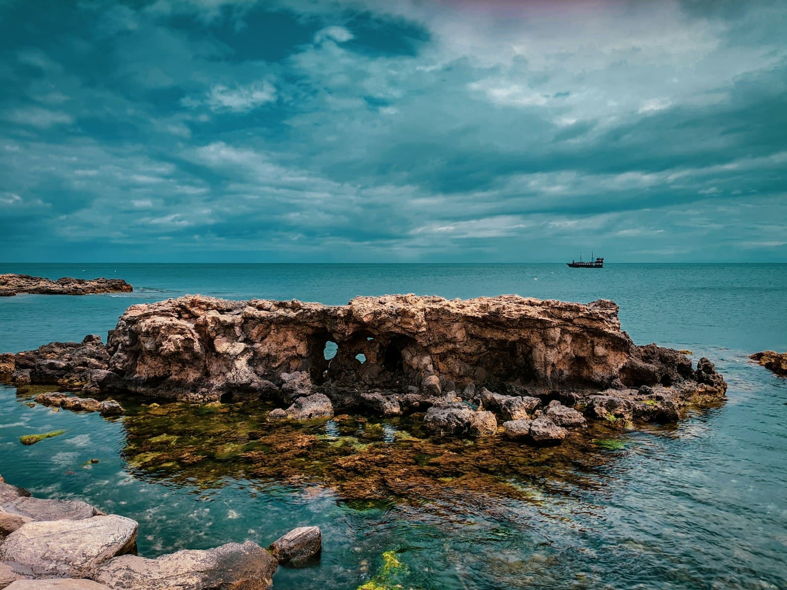 Monastir — a rocky beach with a boat in the water