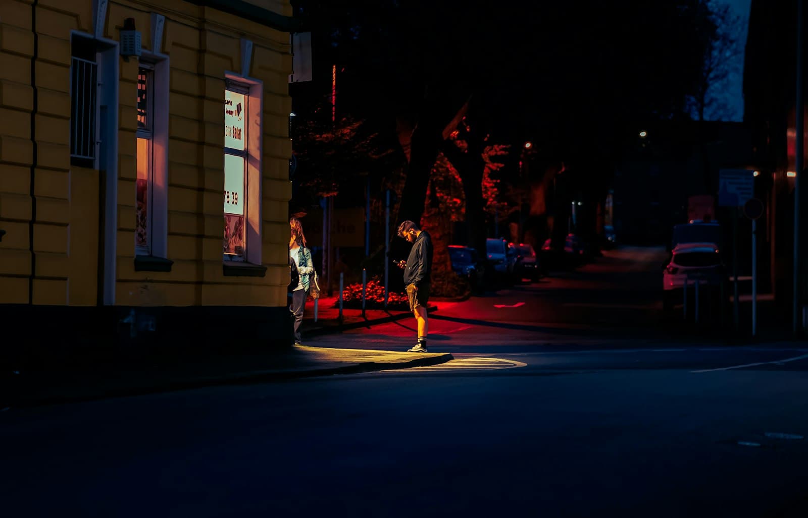 Mönchengladbach — a man and a woman walking down a street at night