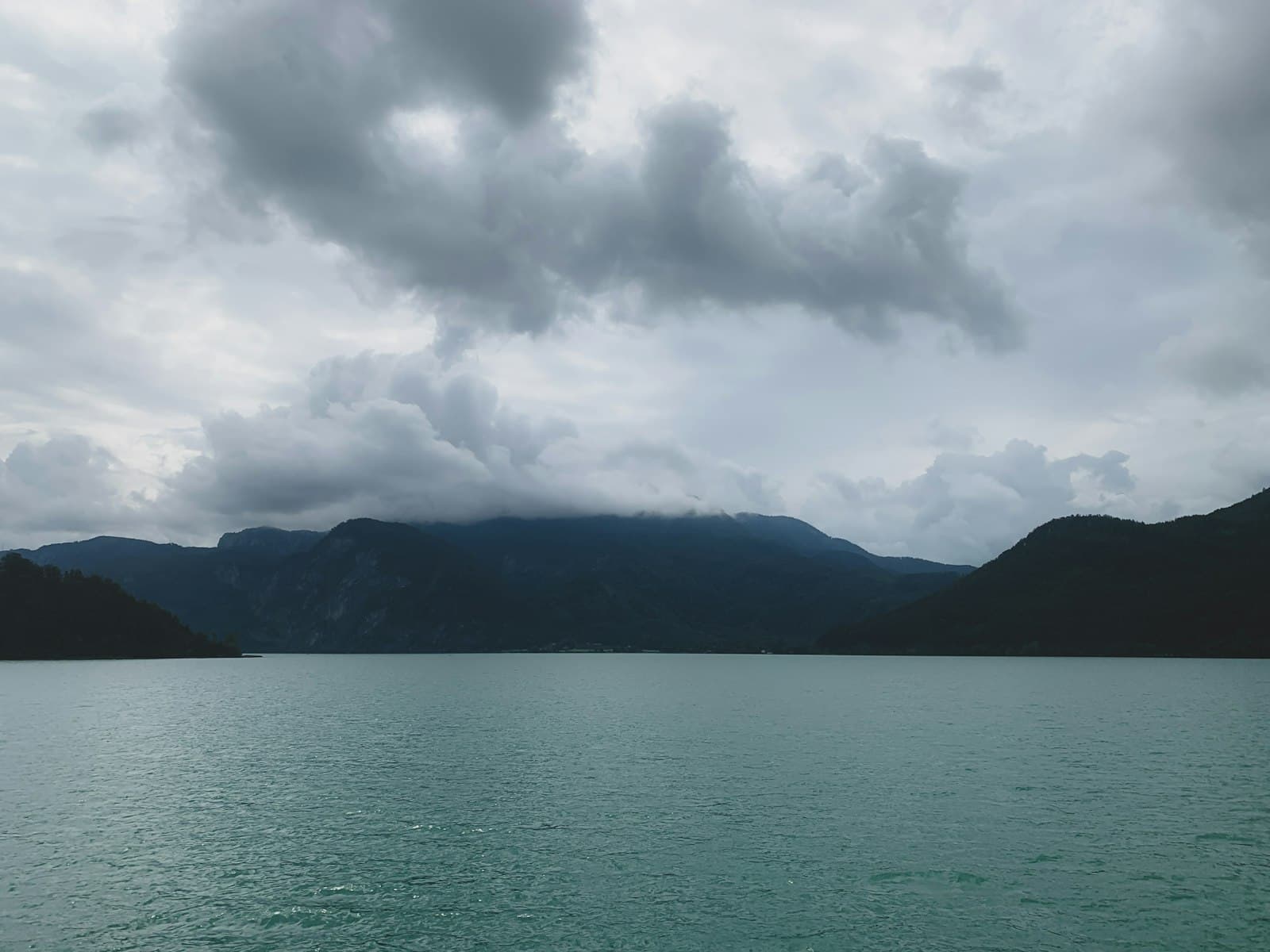 Mondsee — A body of water with mountains in the background