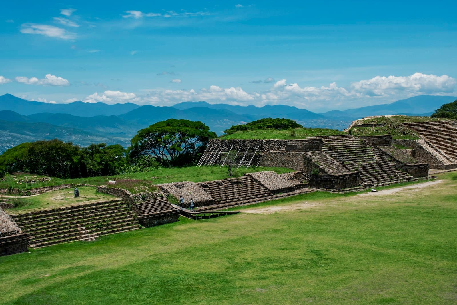 Monte Alban — green grass field under blue sky during daytime