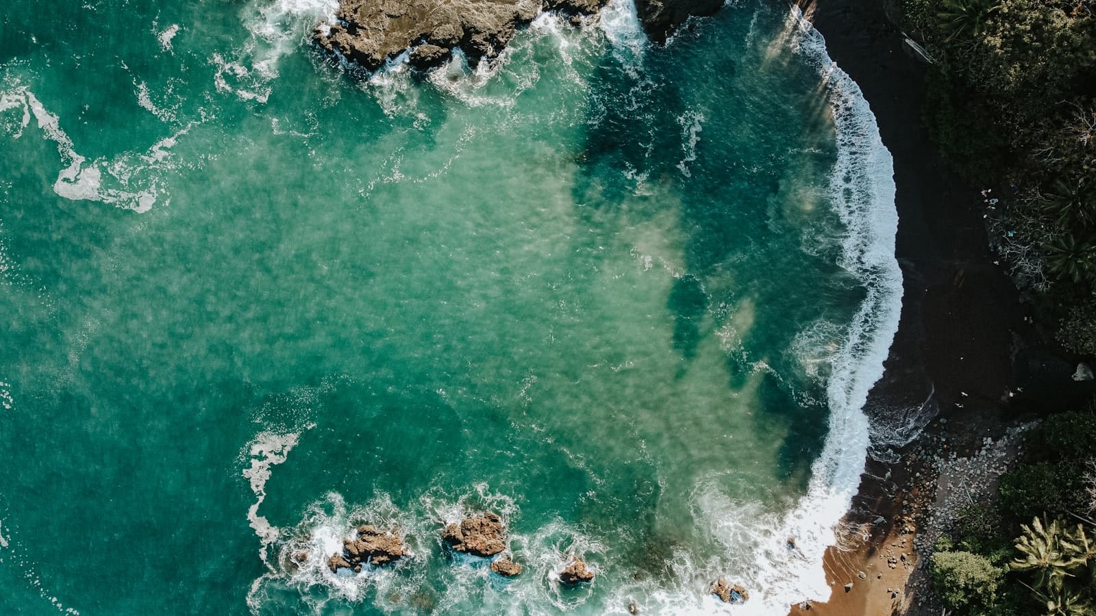 Montezuma — an aerial view of the ocean with waves crashing on the rocks