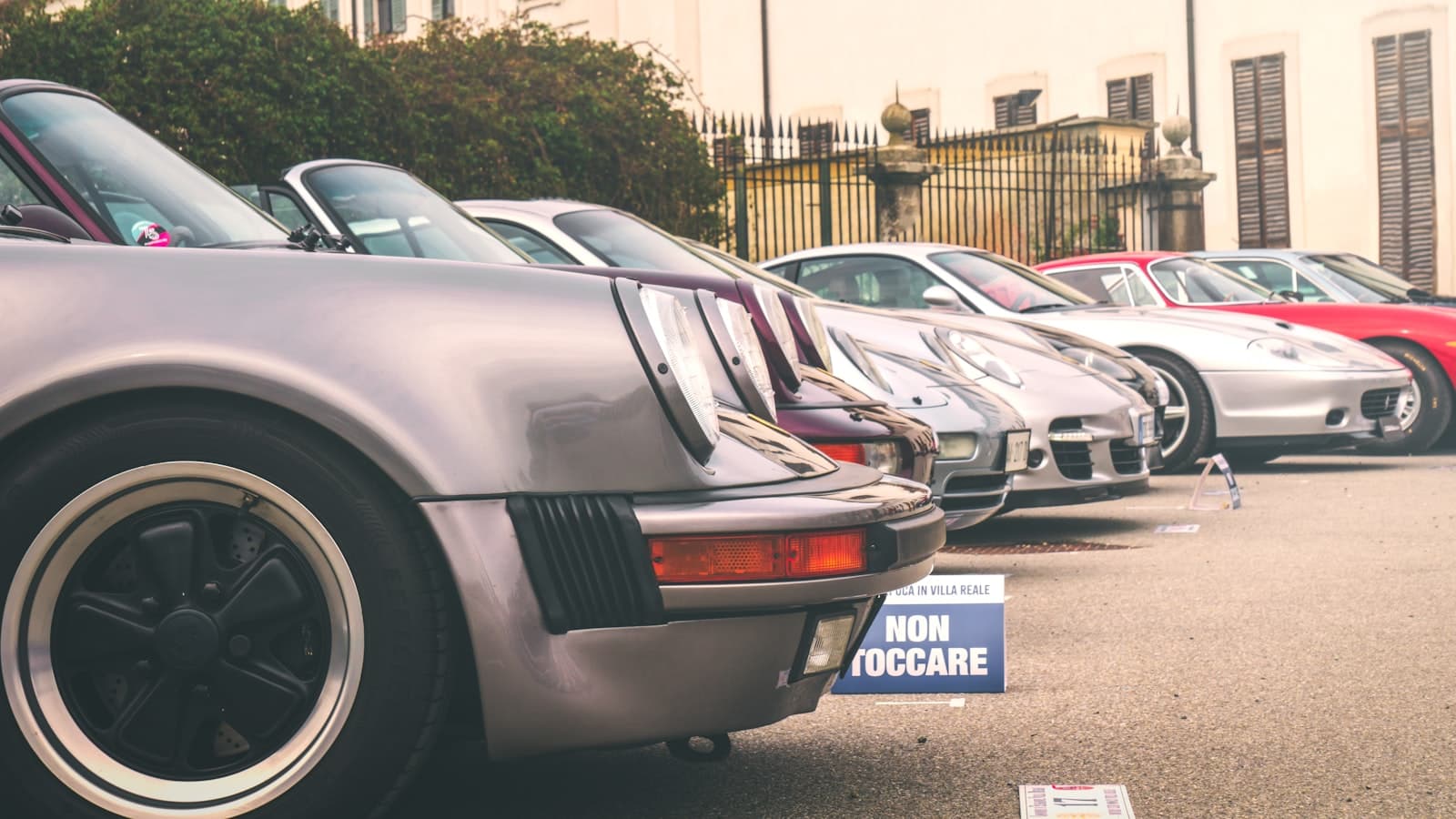 Monza — Classic sports cars are parked in a row.