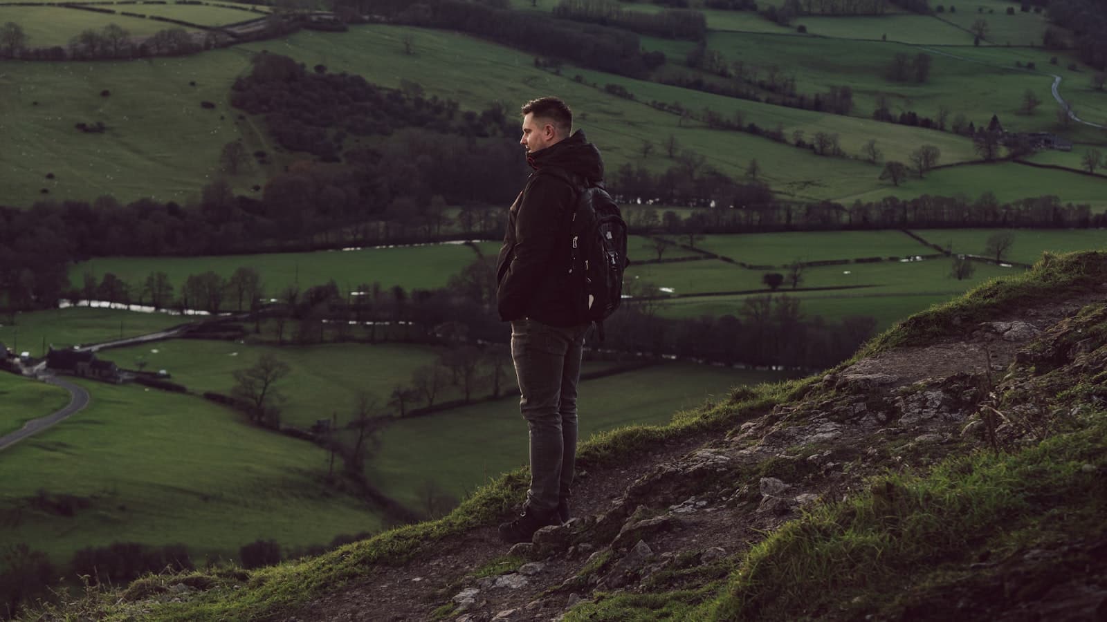 Moreton-in-Marsh — a man standing on top of a lush green hillside