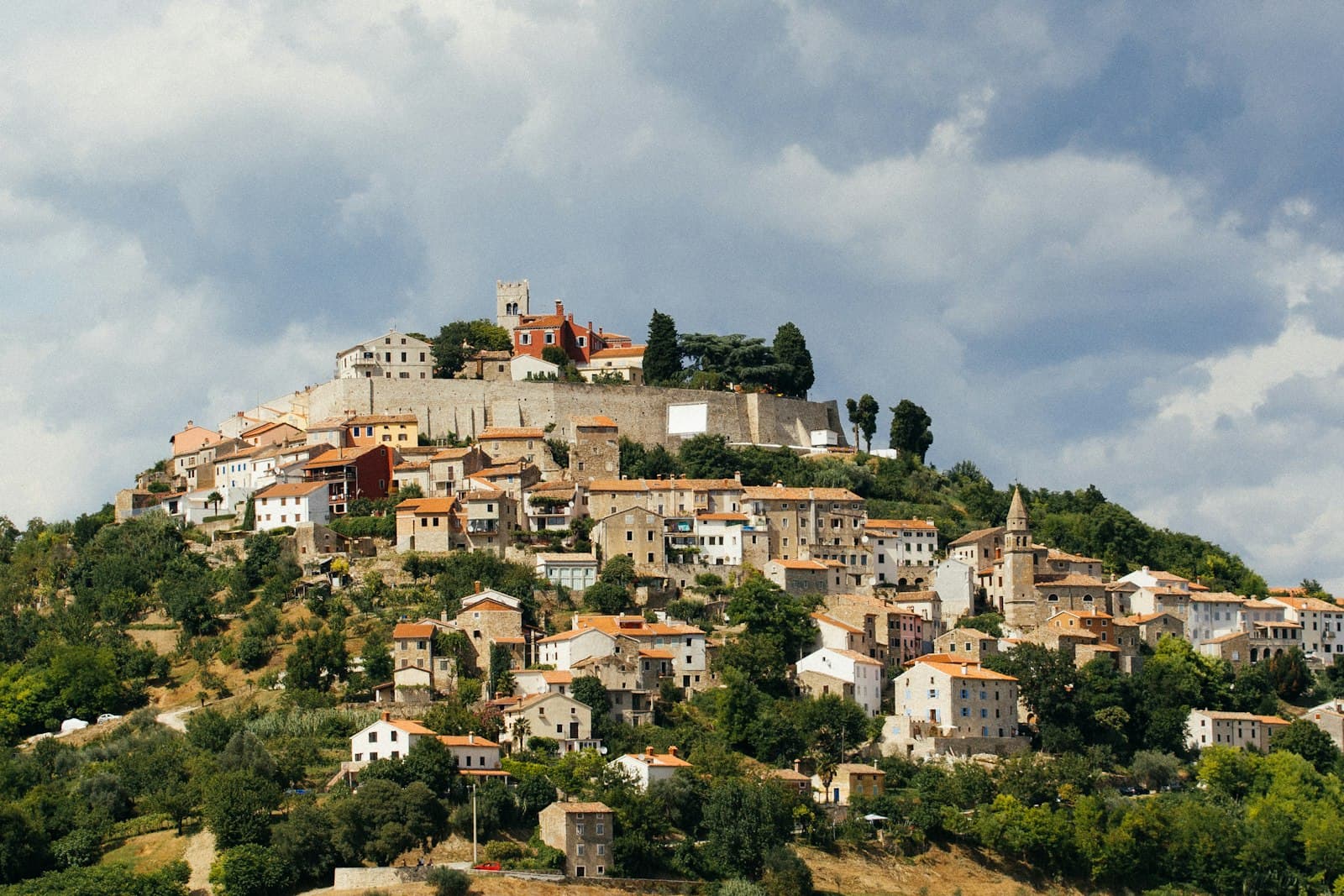 Motovun — white and brown concrete houses under cloudy sky during daytime