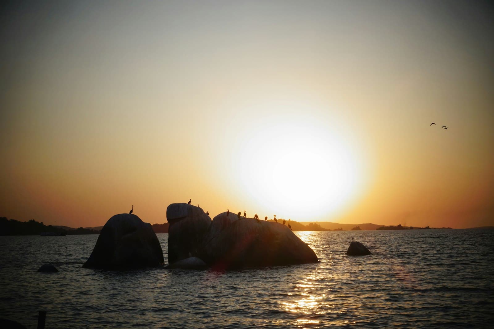 Mwanza — silhouette of rock formation on sea during sunset