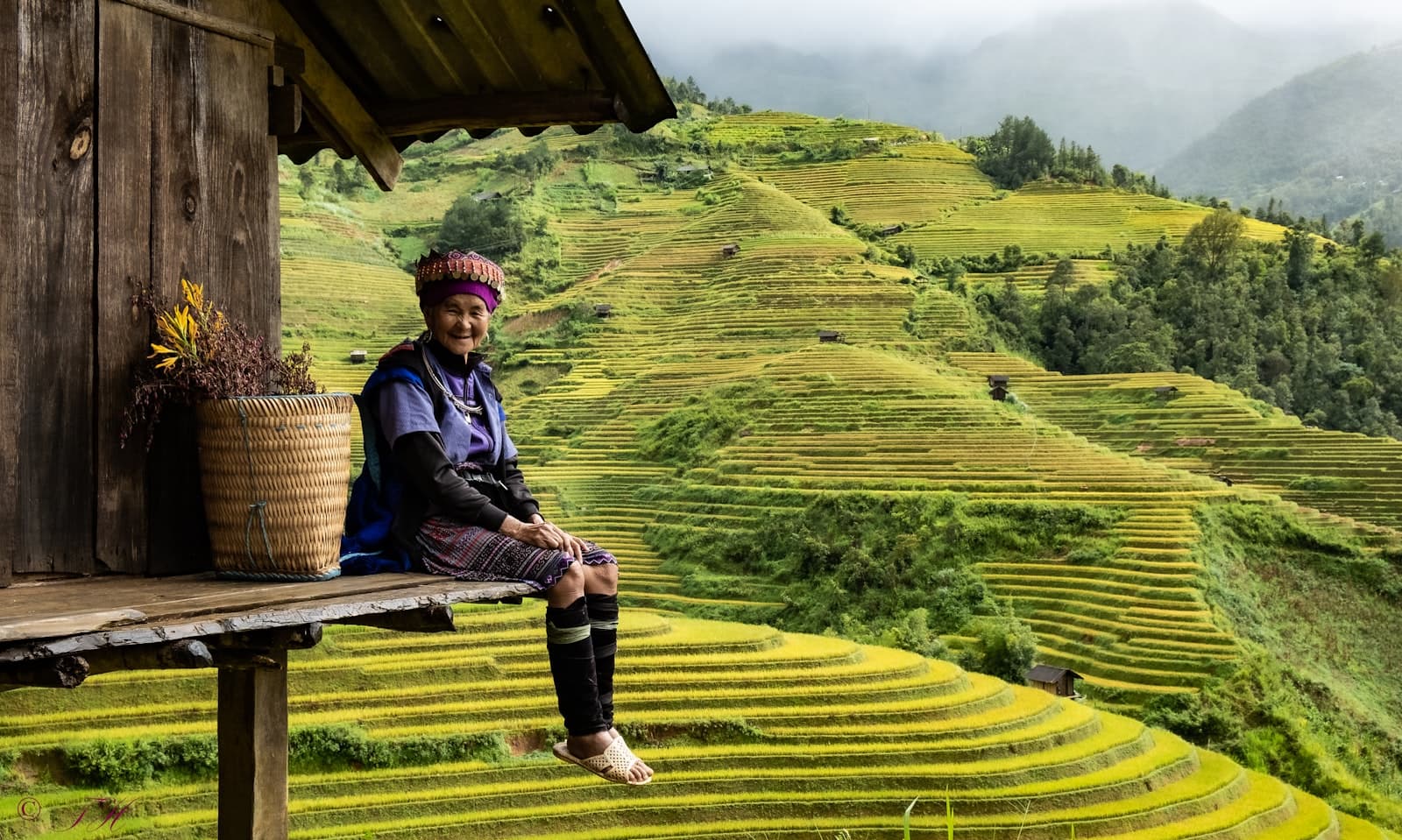 Mỹ Tho — man in blue and white striped long sleeve shirt sitting on brown wooden bench