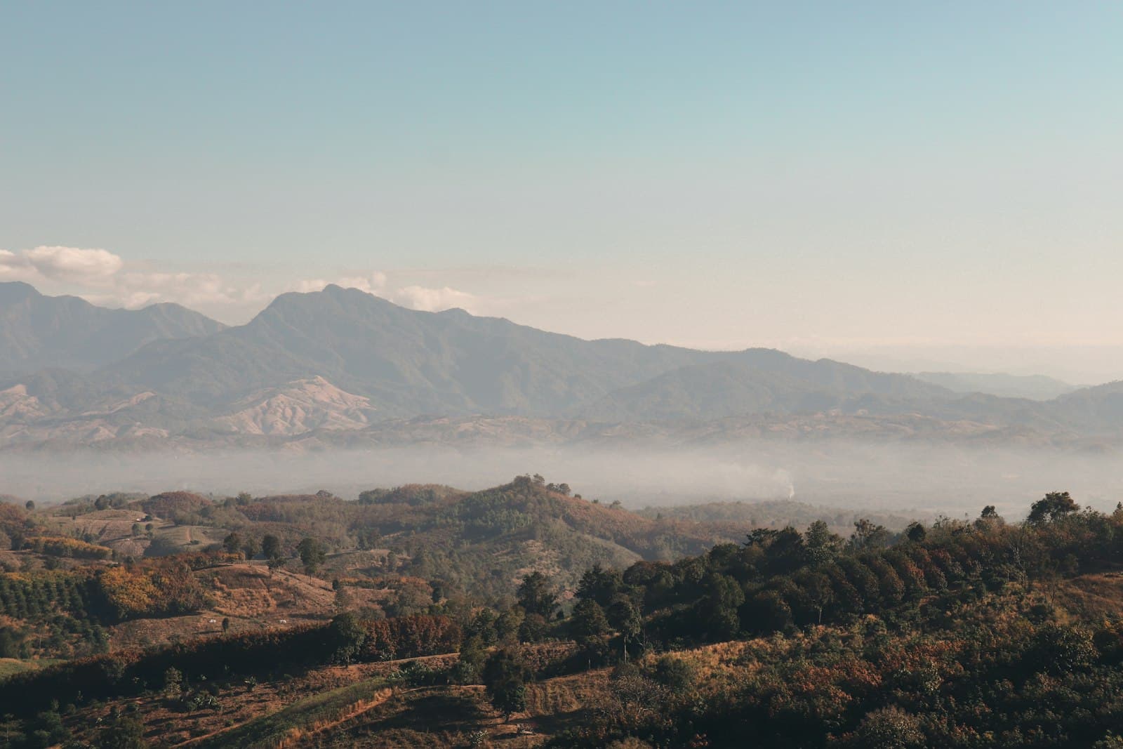 Nan — a view of a mountain range covered in fog