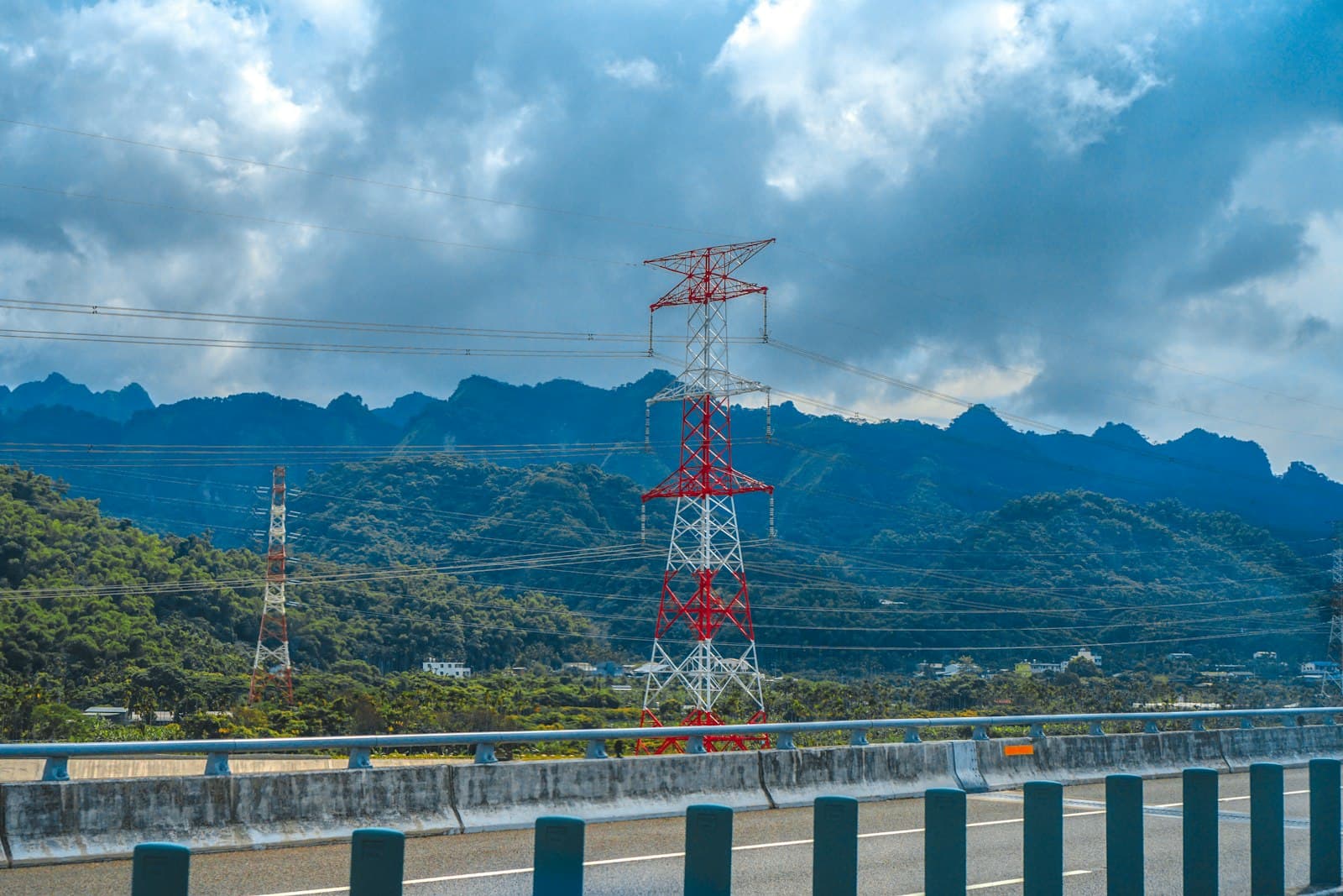 Nantou — red and white tower near green mountain under blue sky during daytime