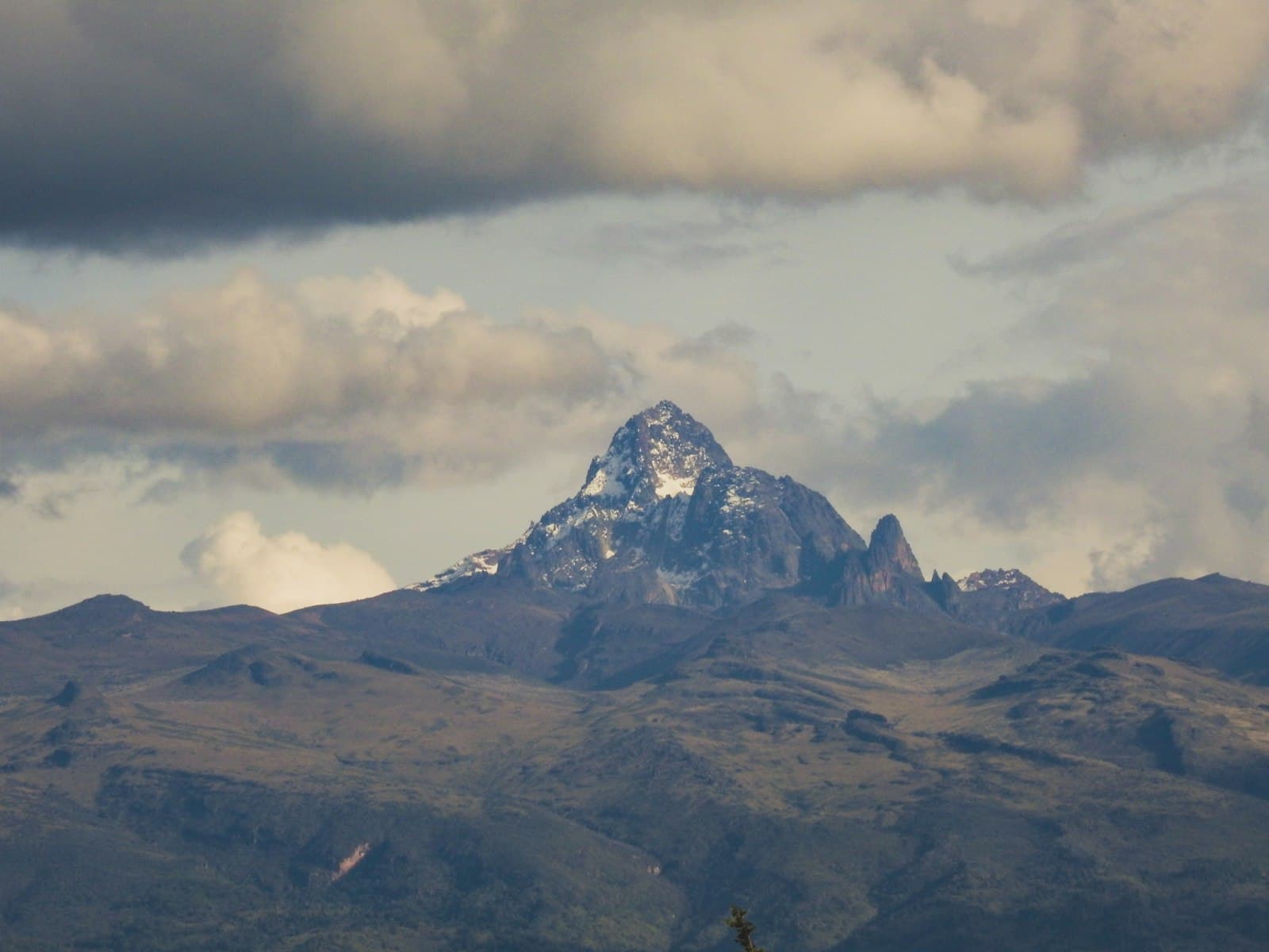 Nanyuki — a mountain with a snow capped peak in the distance