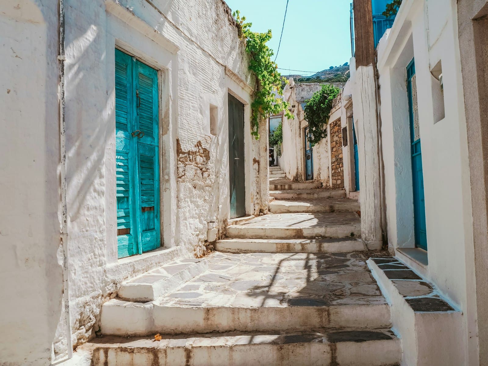 Naxos — blue wooden door on white concrete building