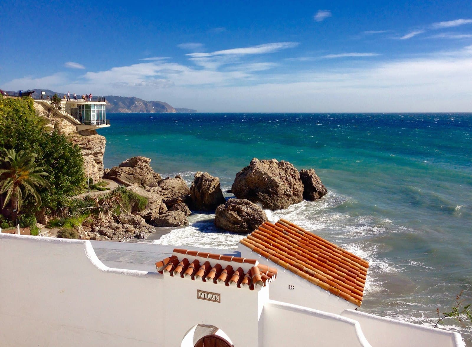 Nerja — white and brown concrete building near sea during daytime