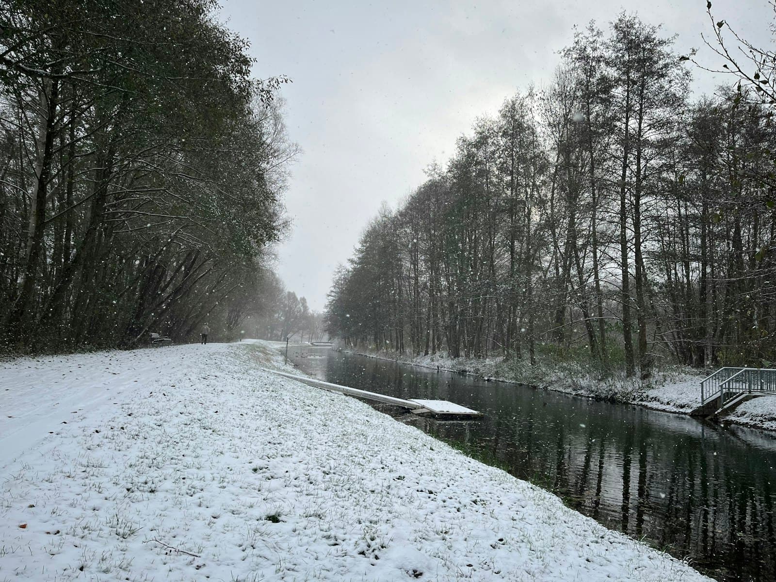Neubrandenburg — a snow covered road next to a river