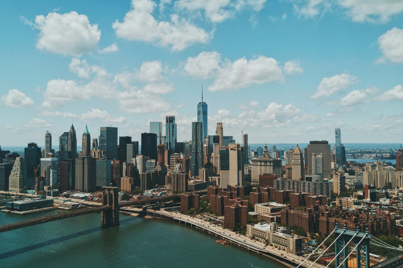 New York — wide angle photo of Brooklyn Bridge under cloudy sky