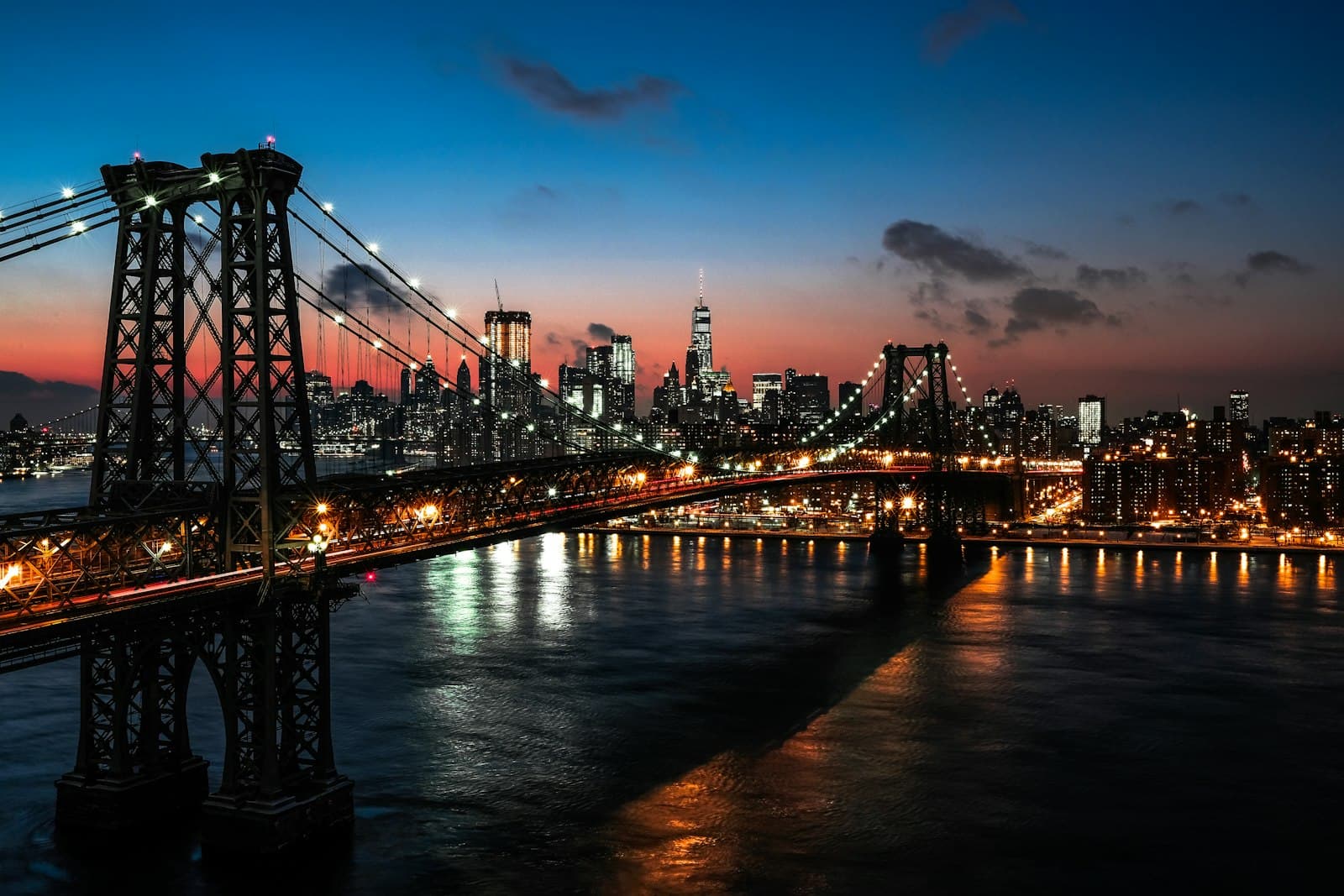 New York — lighted cable bridge near high-rise buildings