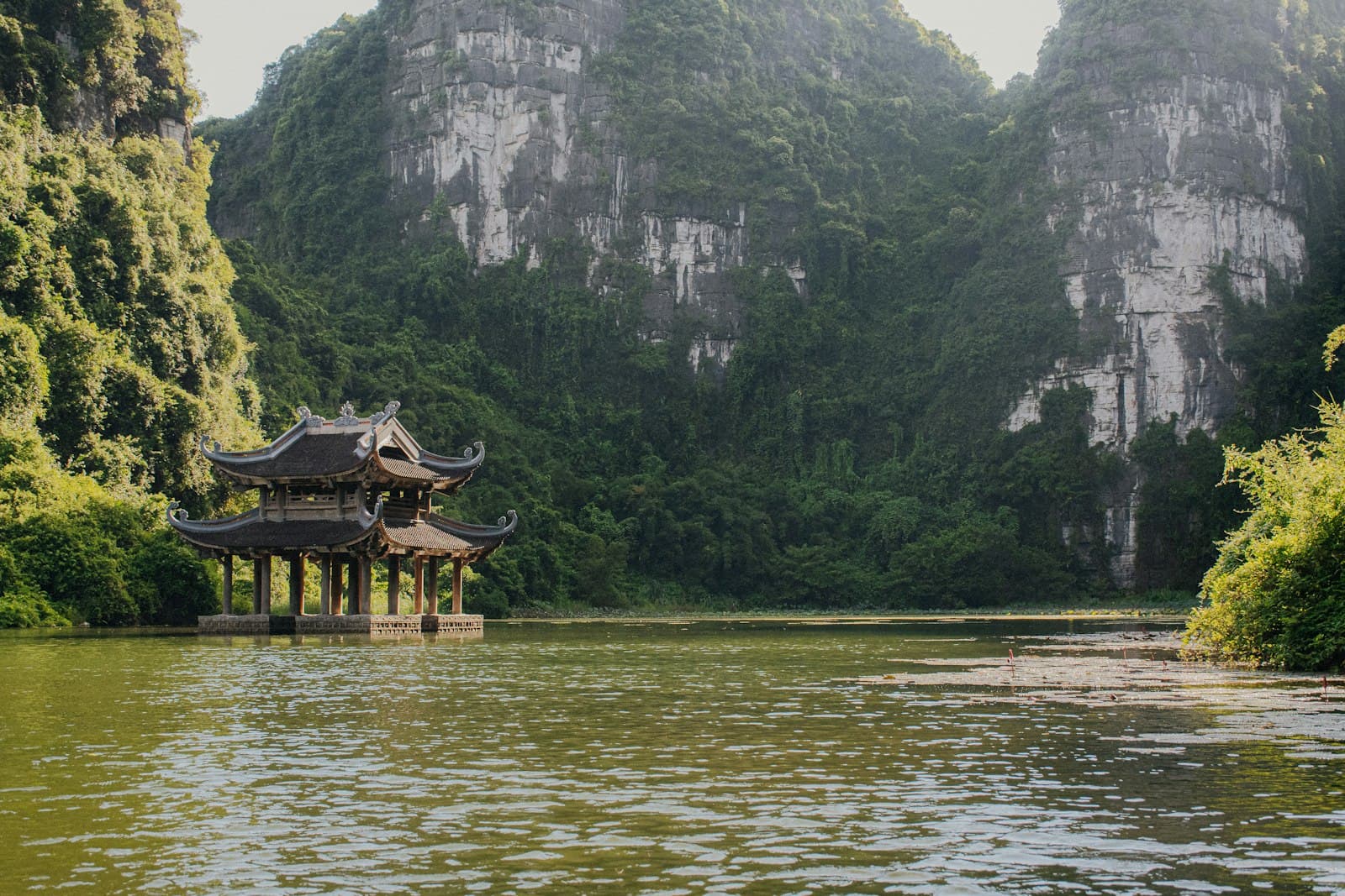 Ninh Bình — a lake with a pavilion in the middle of it