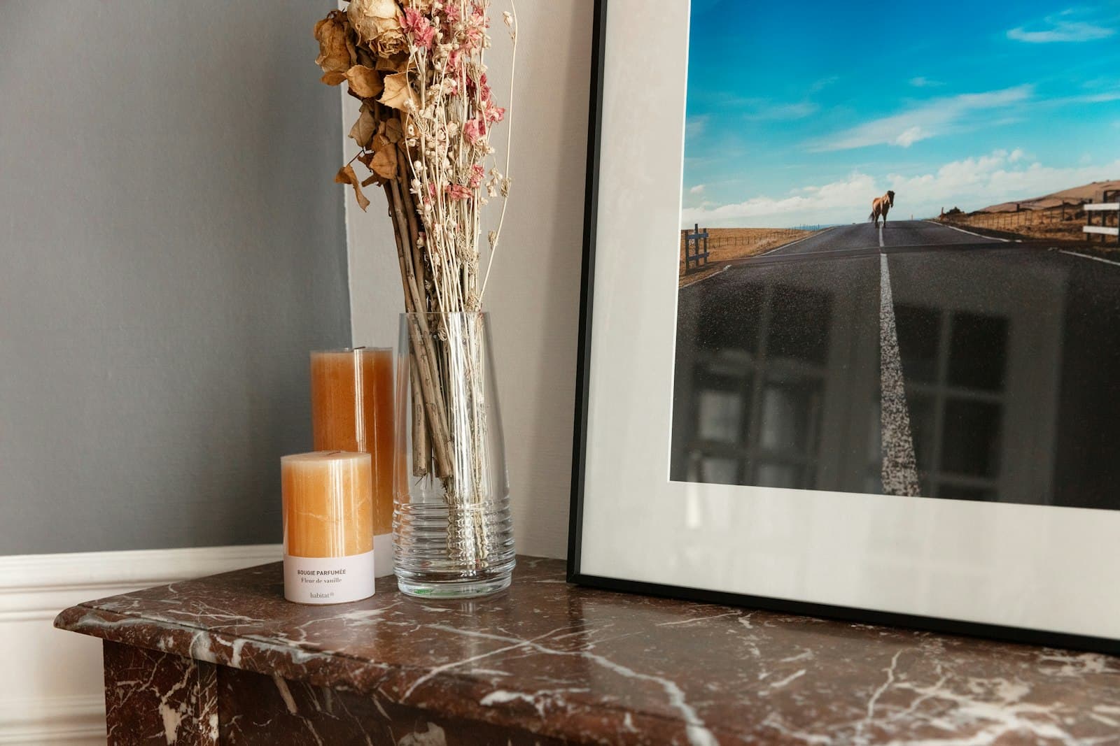 Nogent-sur-Marne — white ceramic mug beside clear glass vase on brown wooden table