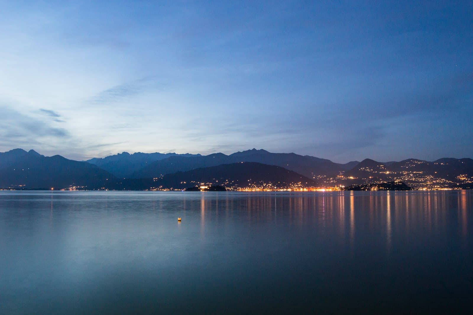 Novara — A body of water with mountains in the background
