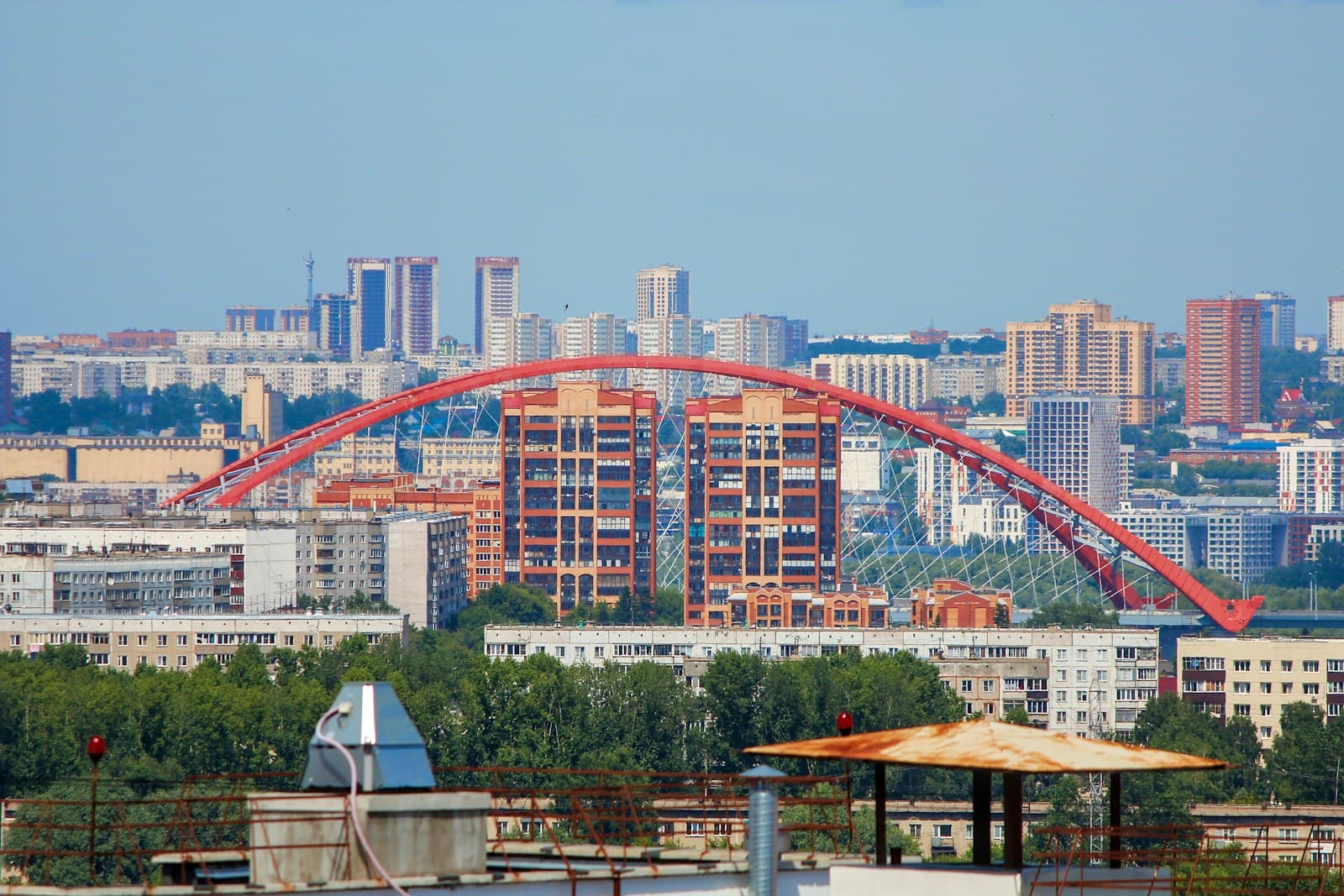 Novosibirsk — red metal bridge over the city during daytime