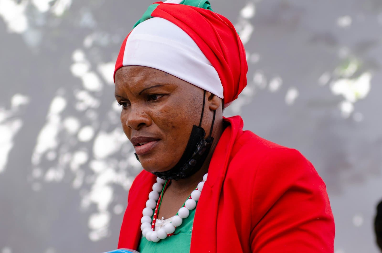 Nuku'alofa — a woman wearing a red jacket and a green shirt