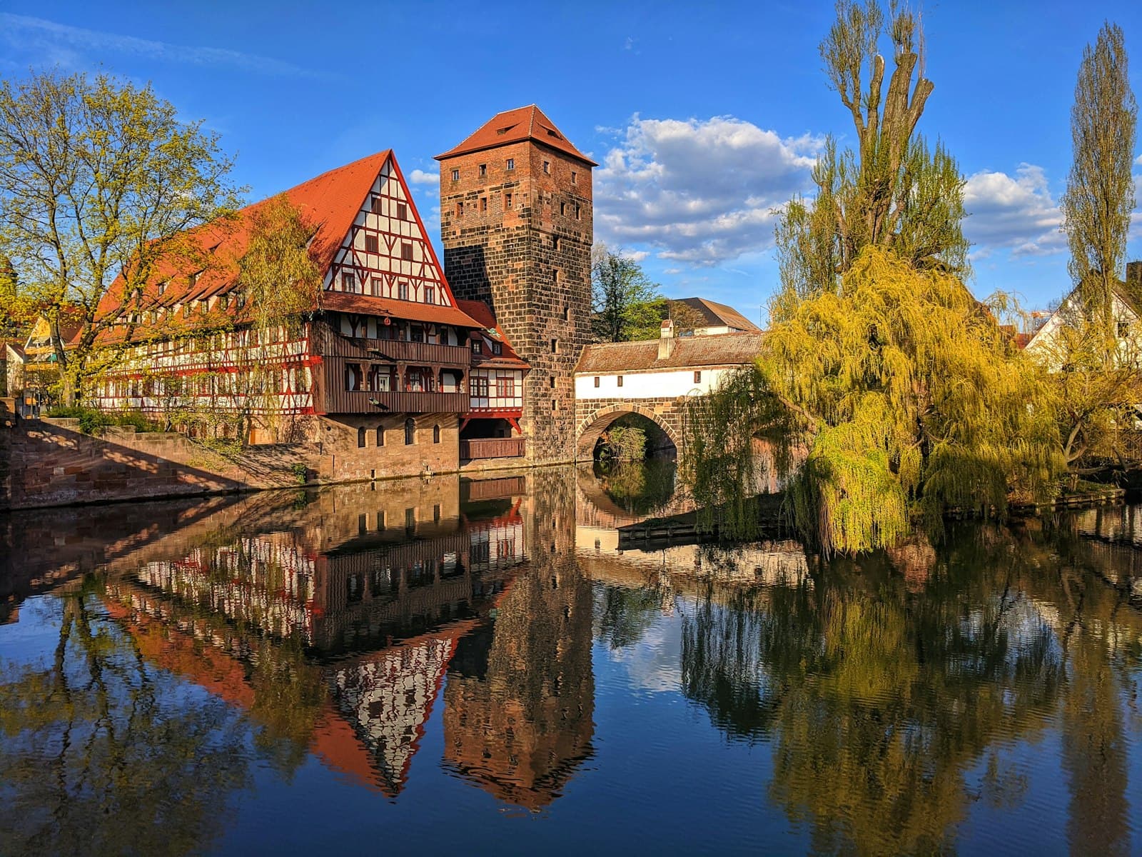 Nuremberg — brown brick building near body of water during daytime