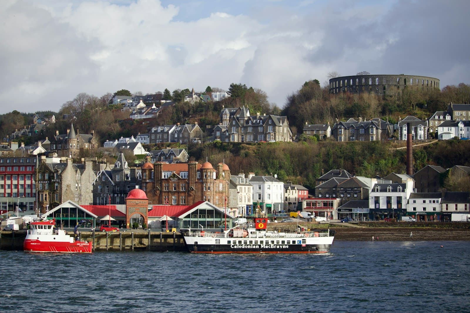 Oban — a boat in the water by a town