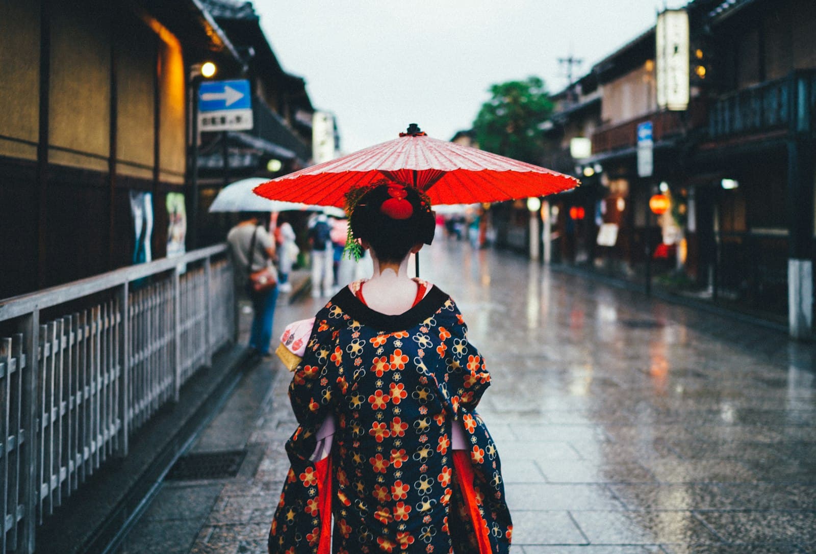 Obuse — woman holding oil umbrella near on buildings