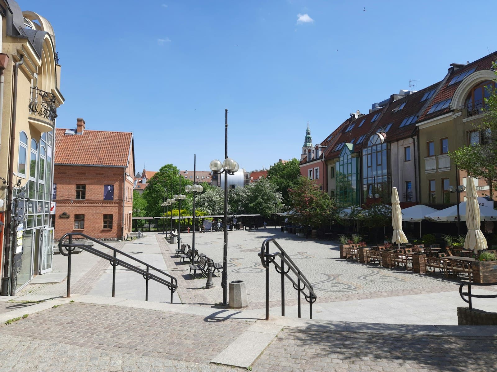 Olsztyn — a city square with a set of stairs leading up to a restaurant